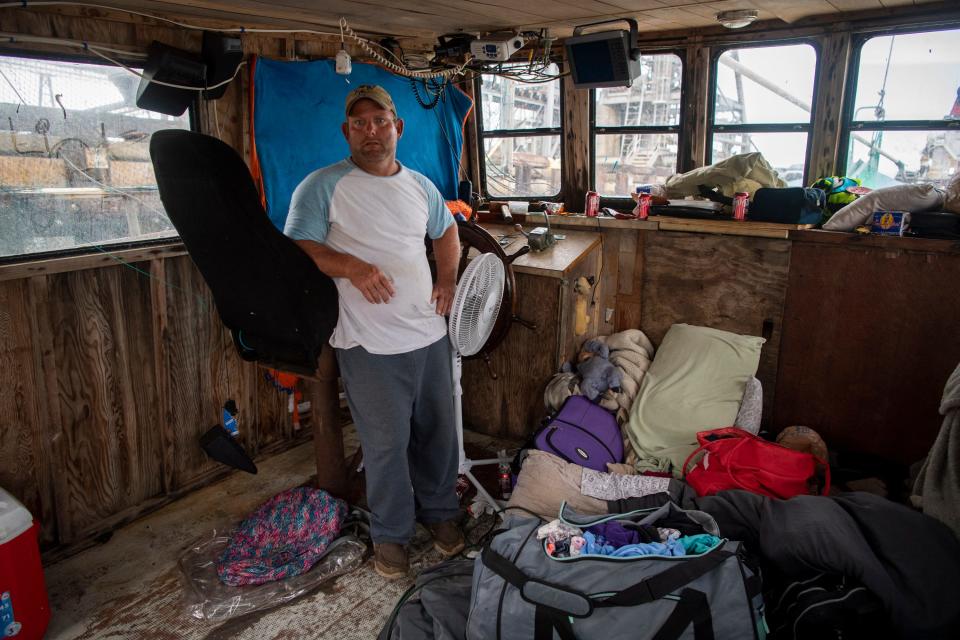 Phillip "Rooster" Dyson stands for a portrait aboard his damaged shrimp boat, Daddy's Girls, in the Port of Lake Charles after it was hammered by Hurricane Laura with him aboard riding out the storm.