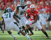 LINCOLN, NE - OCTOBER 29: Running back Aaron Green #2 of the Nebraska Cornhuskers tries to avoid cornerback Darqueze Dennard #31 of the Michigan State Spartans during their game at Memorial Stadium October 29, 2011 in Lincoln, Nebraska. (Photo by Eric Francis/Getty Images)