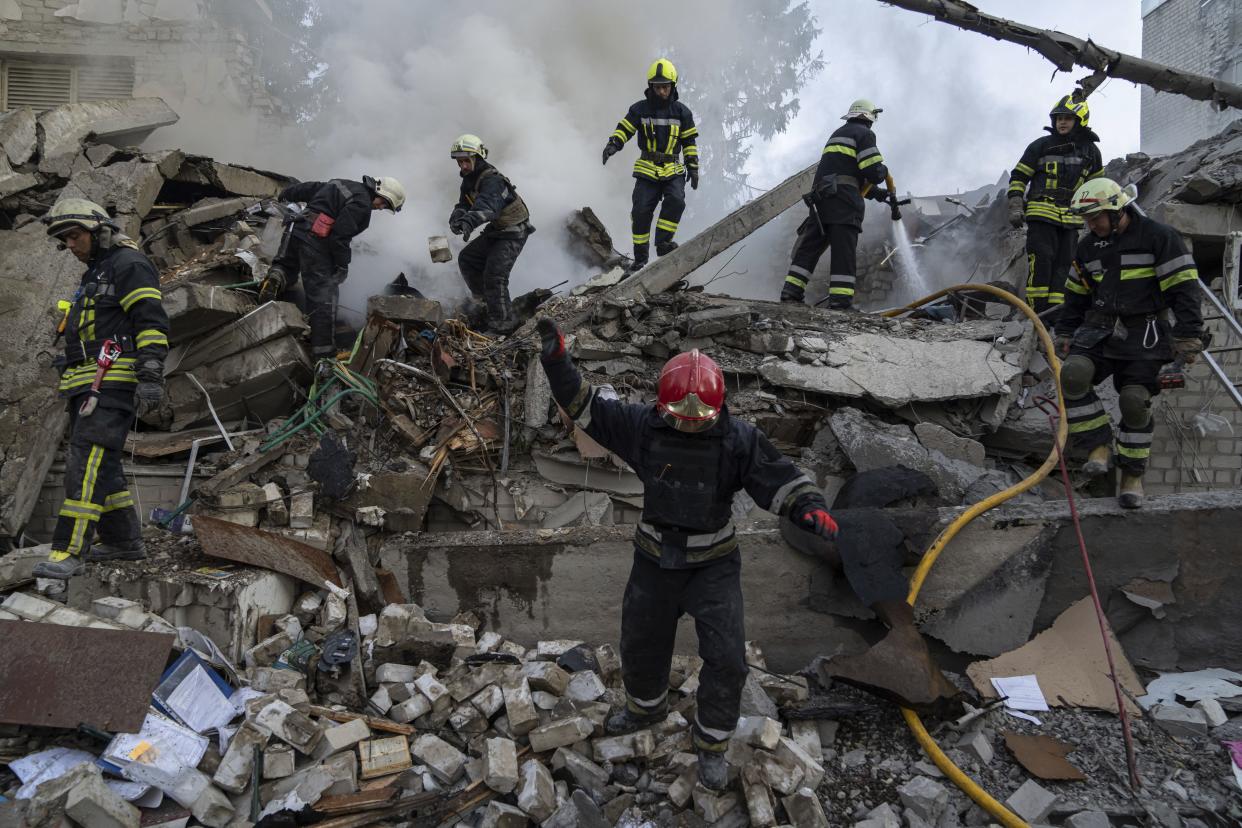 Rescue workers clearing rubble of a destroyed school after an attack in Kharkiv, Ukraine, on Monday, July 4, 2022.