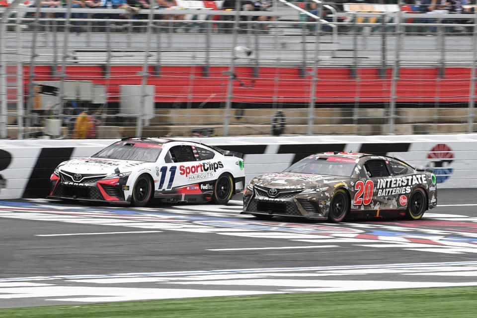 CHARLOTTE, NC - MAY 29: Denny Hamlin (#11 Joe Gibbs Racing Sport Clips Haircuts Toyota) and Christopher Bell (#20 Joe Gibbs Racing Interstate Batteries Toyota) race side by side during the running of the NASCAR Cup Series Coca-Cola 600 on May 29, 2023, at Charlotte Motor Speedway in Concord, NC. (Photo by Jeffrey Vest/Icon Sportswire via Getty Images)