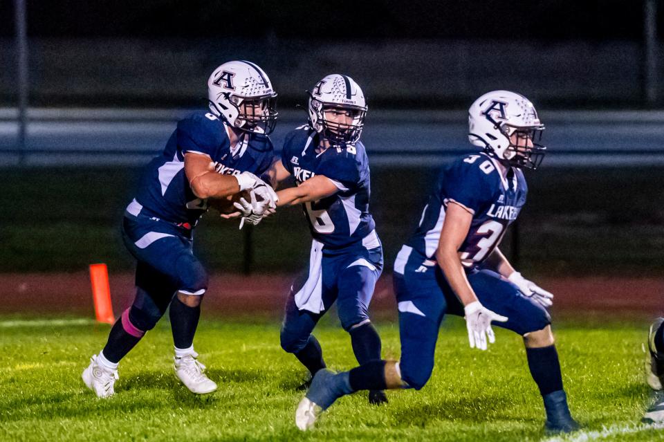 Apponequet's Harrison Lemieux hands the ball off to Jackson Gagnier.