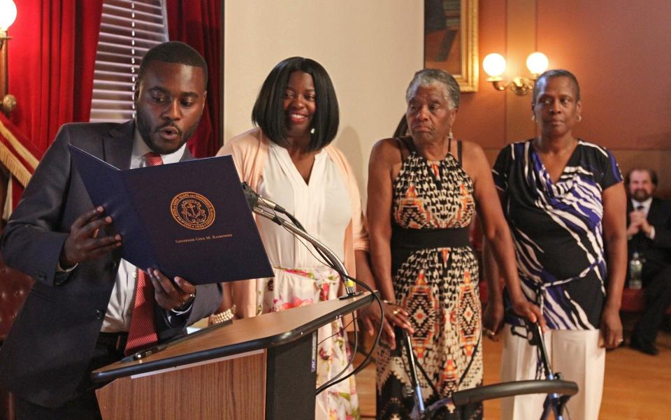 At a news conference in 2017, when he worked in the office of Gov. Gina Raimondo, Gabe Amo reads a proclamation to Viola Davis and her family honoring her work in film.