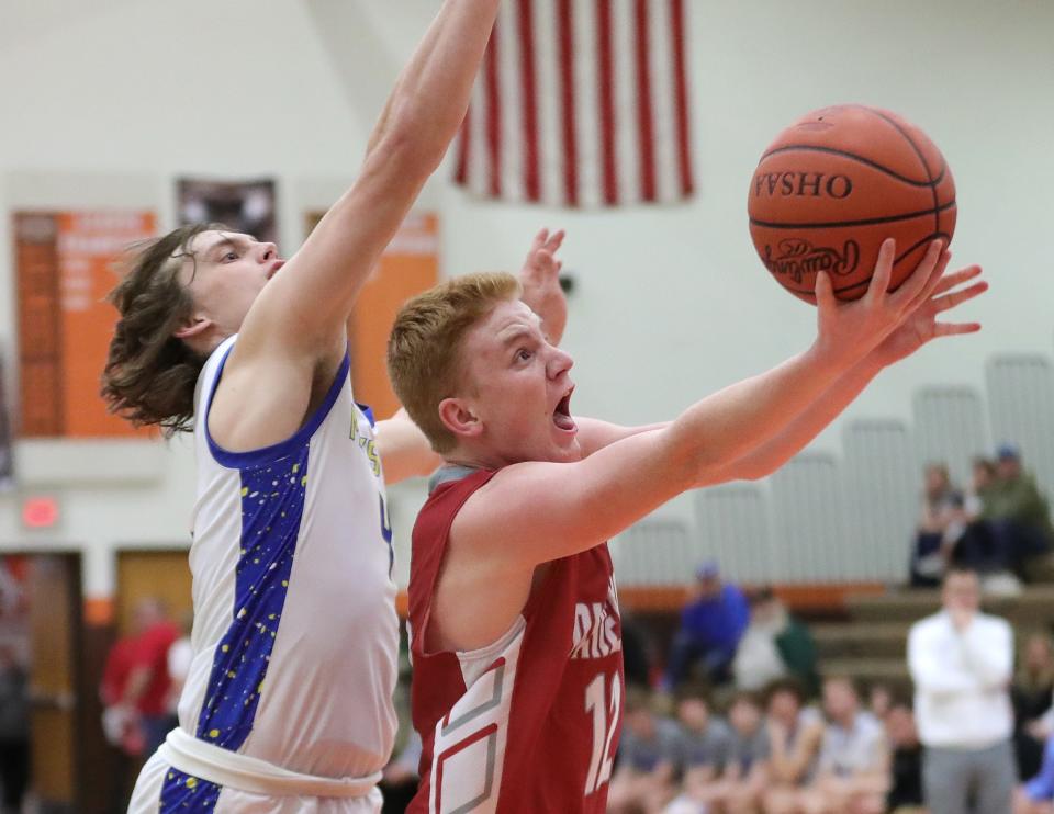 Minerva's Rowen Hoffee, right, puts up a shot defended by Maysville's Alex Bobb during a district semifinal, Wednesday, March 6, 2024, at Claymont High School.