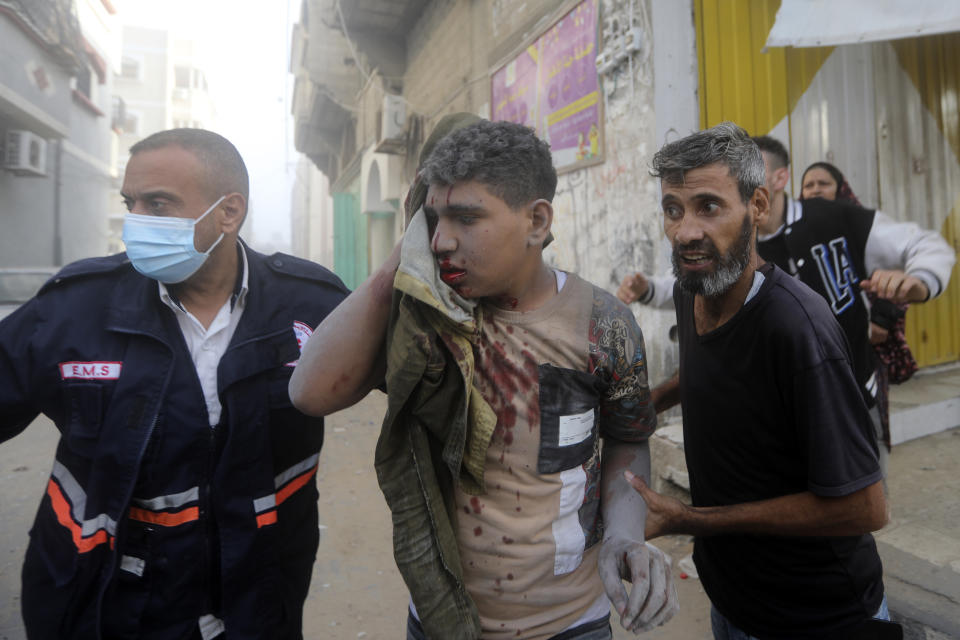 Palestinians evacuate a wounded youth following an Israeli airstrike in Khan Younis refugee camp, southern Gaza Strip, Tuesday, Nov. 7, 2023. (AP Photo/Mohammed Dahman)