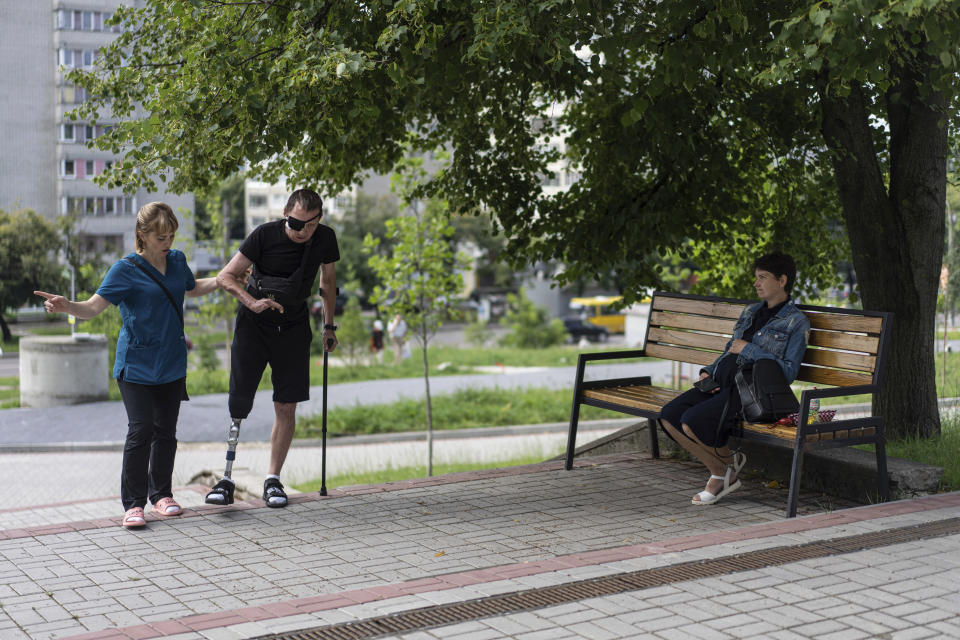 Roman Yarmolenko, a Ukrainian soldier of the 93rd brigade, learns to walk on a prosthesis by practicing on the stairs outside the Unbroken rehabilitation in Lviv, Ukraine, Wednesday, July 26, 2023. Yarmolenko was a grenade launcher fighting in the Kharkiv region near Russia's border when he was wounded. Ukraine is facing the prospect of a future with upwards of 20,000 amputees, many of them soldiers who are also suffering psychological trauma from their time at the front. (AP Photo/Evgeniy Maloletka)