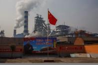 A poster showing Chinese President Xi Jinping is seen in front of the Xinyuan Steel plant in Anyang, Henan province, China, February 19, 2019. REUTERS/Thomas Peter