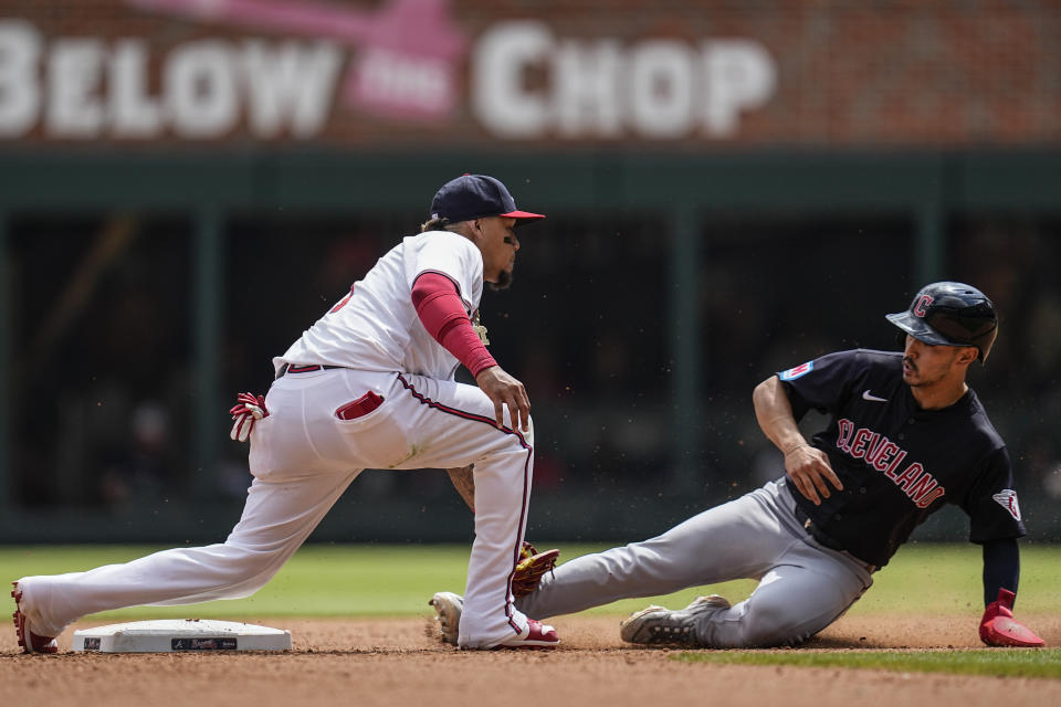 Cleveland Guardians' Steven Kwan (38) attepts a steal of second base against Atlanta Braves shortstop Orlando Arcia (11) in the xx inning of a baseball game, Sunday, April 28, 2024, in Atlanta. Kwan, was out at second base. (AP Photo/Mike Stewart)