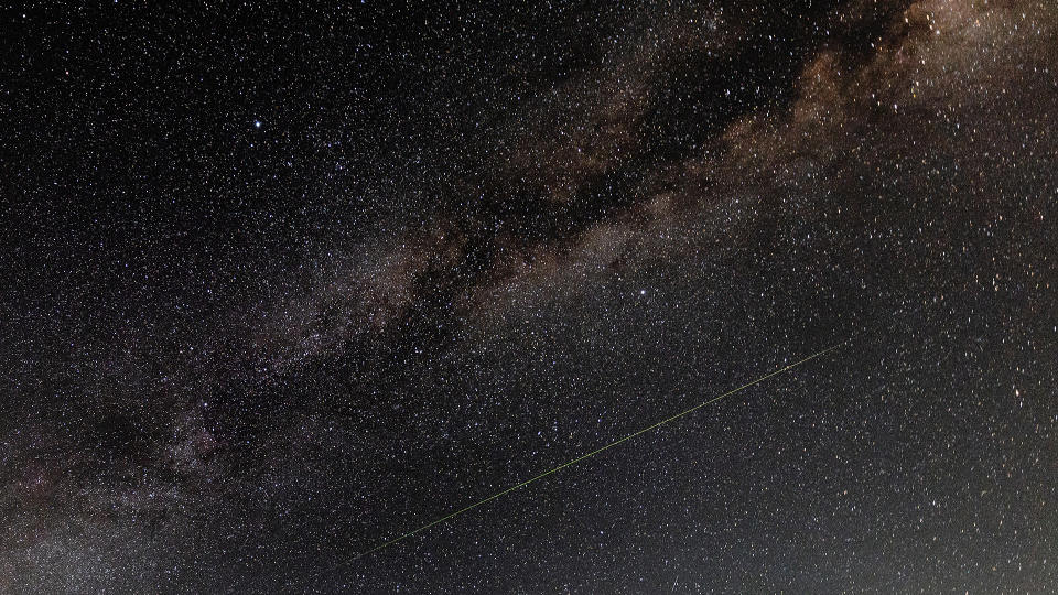 A meteor streaks across the sky during the Perseid meteor shower.