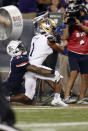 Arizona safety Jaxen Turner (21) tackles Washington wide receiver Terrell Bynum (1) during the second half of an NCAA college football game Friday, Oct. 22, 2021, in Tucson, Ariz. (AP Photo/Chris Coduto)