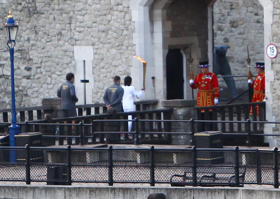 Dame Kelly Holmes
holds the Olympic Flame outside the entrance to the Tower of London
London, England - 20.07.12
Mandatory Credit: WENN.com