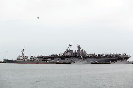 The damaged USS John McCain (L) and the USS America are docked at Changi Naval Base in Singapore August 22, 2017. REUTERS/Calvin Wong NO RESALES. NO ARCHIVES