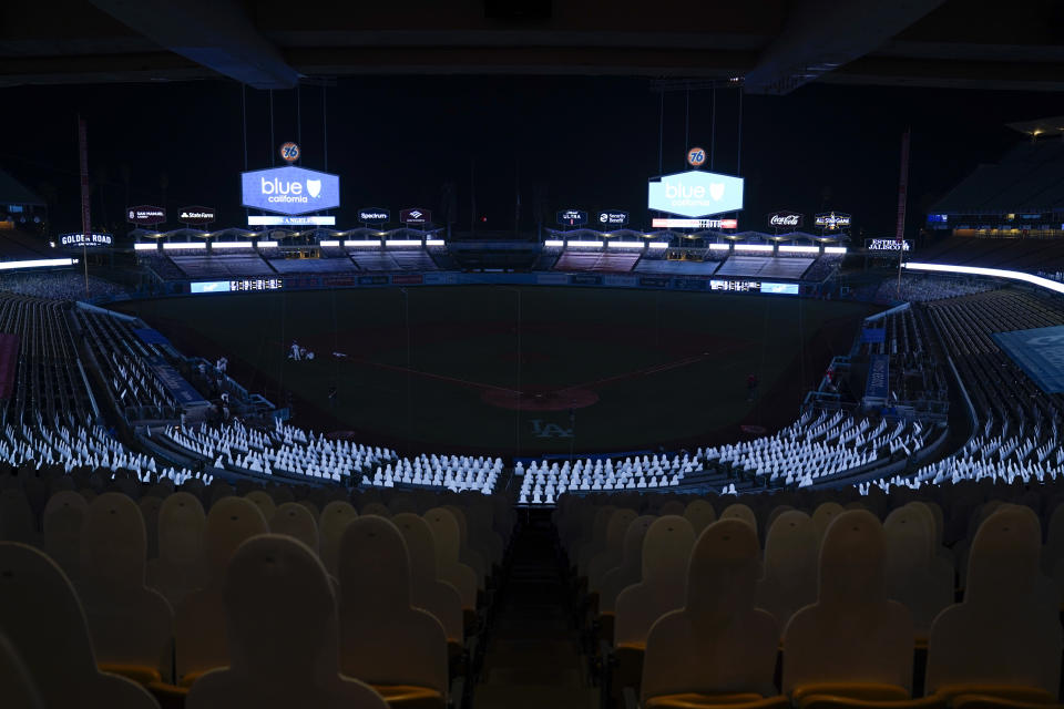 Players leave the field after a power outage during the seventh inning of a baseball game between the Los Angeles Angels and the Los Angeles Dodgers, Saturday, Sept. 26, 2020, in Los Angeles. (AP Photo/Ashley Landis)