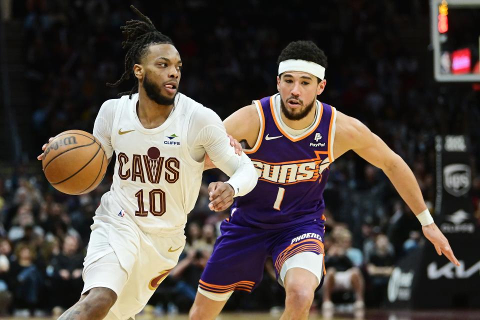 Cleveland Cavaliers guard Darius Garland (10) drives to the basket against Phoenix Suns guard Devin Booker (1) during the second half at Rocket Mortgage FieldHouse in Cleveland on March 11, 2024.