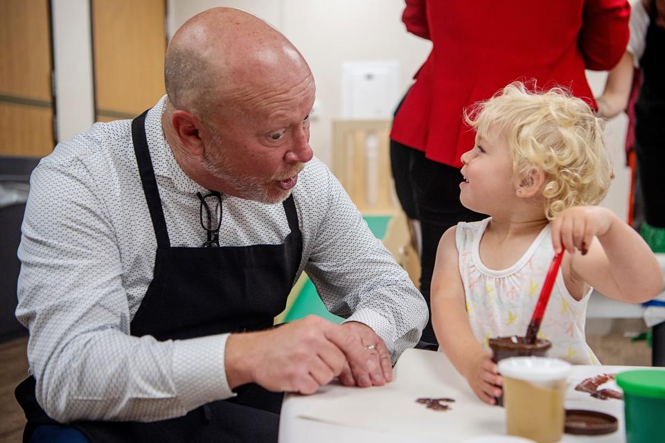 Tim Blenco, with the YMCA, paints with children at the Verner Center for Early Learning June 27, 2023 in Asheville.