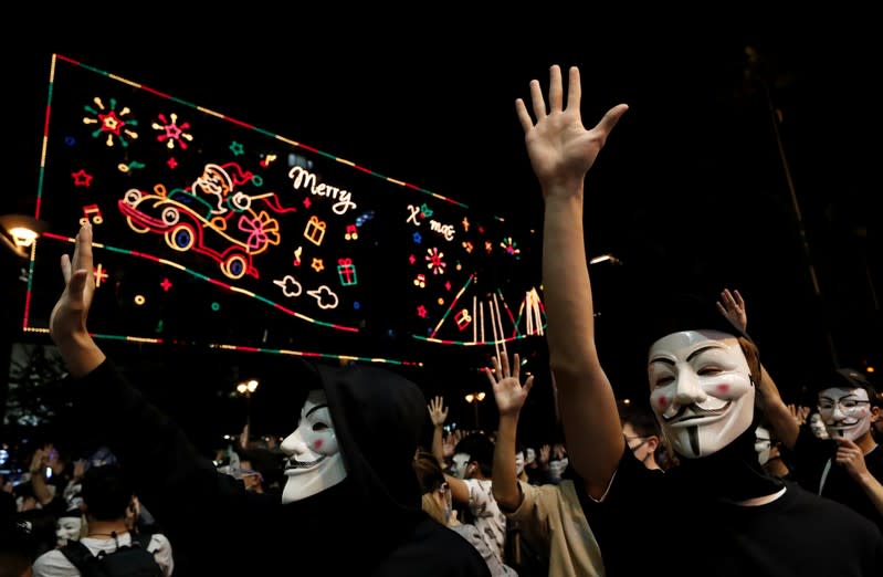 Protesters wearing Guy Fawkes masks attend an anti-government demonstration in Hong Kong