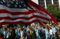 <p>Protesters dressed as the Statue of Liberty march under a US flag during a demonstration in the center of Brussels on May 24, 2017. Demonstrators marched in Brussels ahead of a visit of US President Donald Trump and a NATO heads of state summit which will take place on Thursday. (Photo: Peter Dejong/AP) </p>