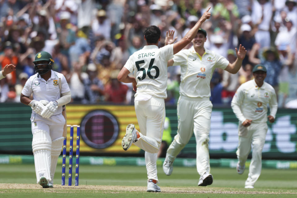 Australia's Mitchell Starc celebrates after taking the wicket of South Africa's Temba Bavuma, left, during the second cricket test between South Africa and Australia at the Melbourne Cricket Ground, Australia, Monday, Dec. 26, 2022. (AP Photo/Asanka Brendon Ratnayake)