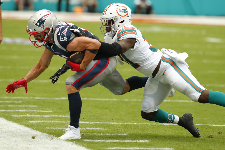 Miami Dolphins defensive back Ken Webster (31) tackles New England Patriots wide receiver Julian Edelman (11), during the first half at an NFL football game, Sunday, Sept. 15, 2019, in Miami Gardens, Fla. (AP Photo/Wilfredo Lee)