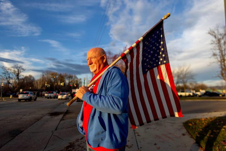 Brad Pike, a retired Santa Clara County fire captain, holds an American flag while campaigning for mayor in Eagle. Pike won the Dec. 5 runoff, defeating incumbent Jason Pierce.