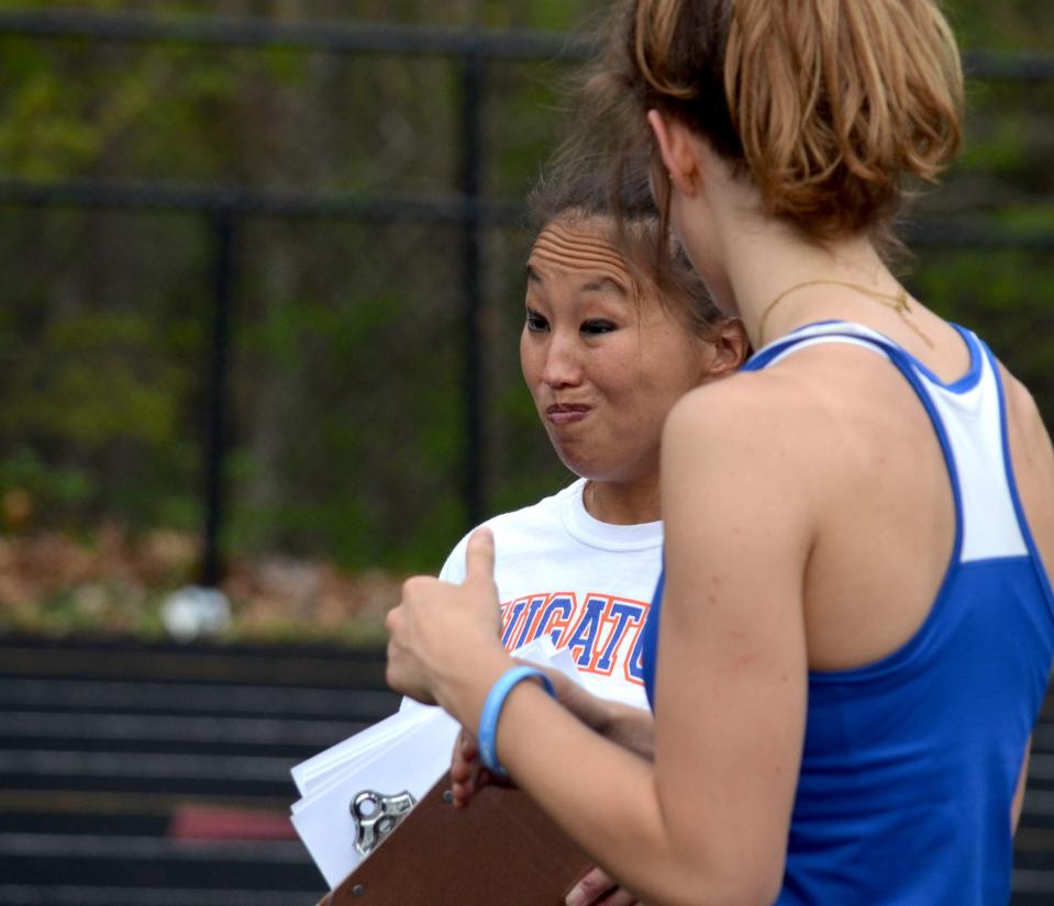 Saugatuck track and field coach Angelina Bauer coaches Aerin Baker in the high jump.