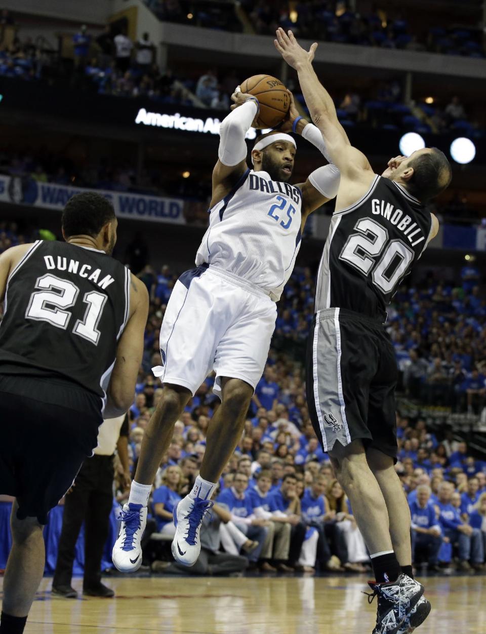 San Antonio Spurs' Tim Duncan (21) watches as Dallas Mavericks' Vince Carter (25) passes the ball under pressure from Spurs' Manu Ginobili (20), of Argentina, in the first half of Game 6 of an NBA basketball first-round playoff series on Friday, May 2, 2014, in Dallas. (AP Photo/Tony Gutierrez)