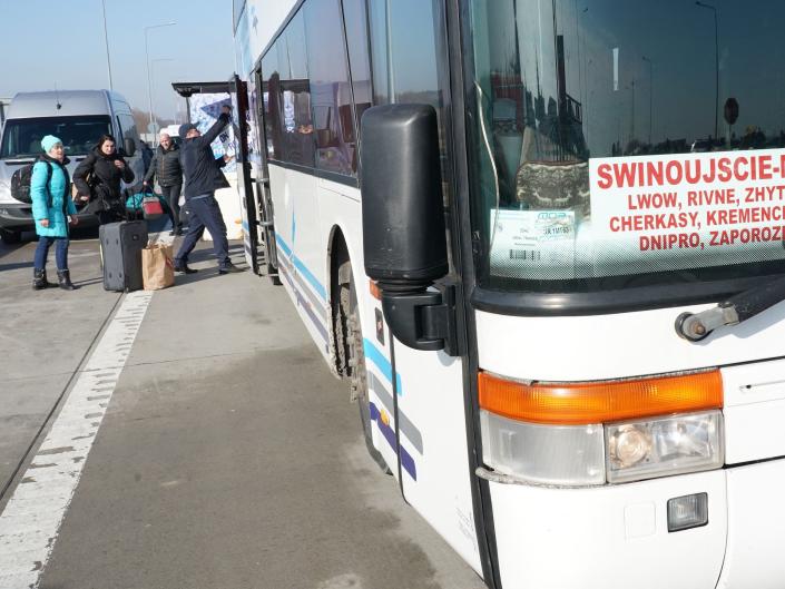 Ukrainian citizens are seen in front of a bus linking the Polish city of Swinoujscie with the Ukrainian city of Mariupol