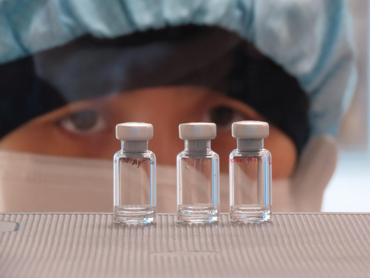 A scientist checks quality control of vaccine vials for correct volume at the Clinical Biomanufacturing Facility (CBF) in Oxford, Britain, April 2, 2020. (Sean Elias via Reuters)