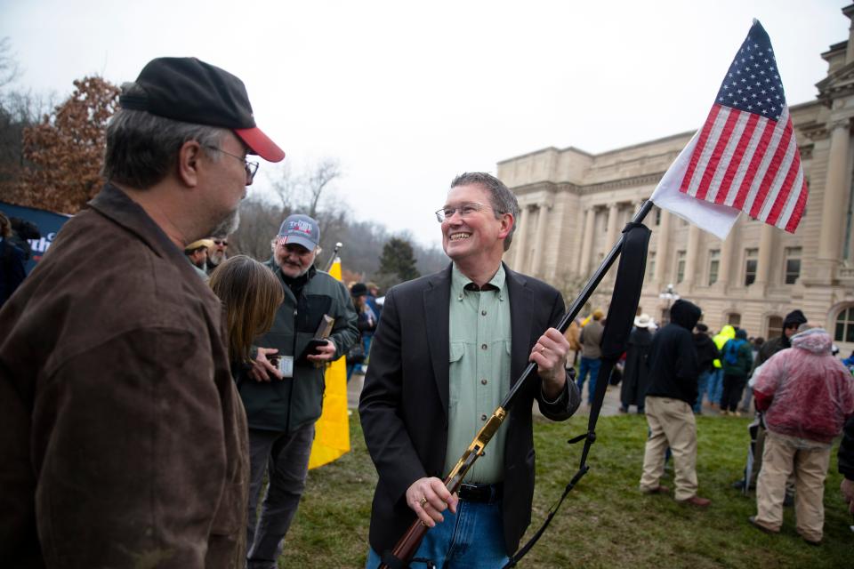 U.S. Rep. Thomas Massie holds Gary Glass's gun after greeting him at a second amendment rally outside the Kentucky State Capitol building in Frankfort, Ky. on Friday. Jan. 31, 2020. Photograph published in February 2020.