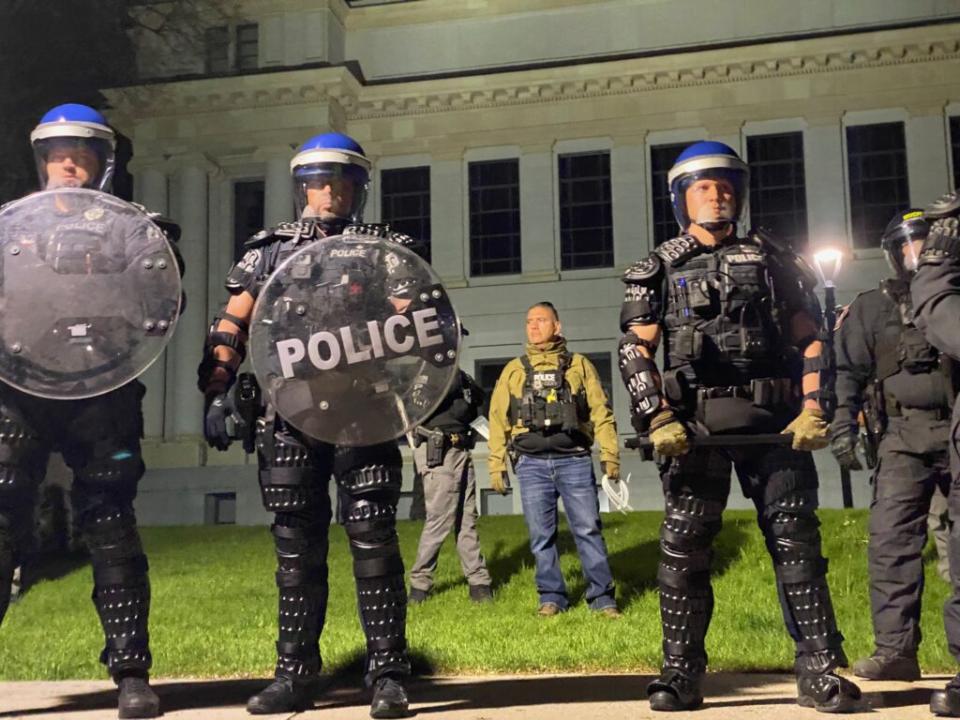 Police officers wearing riot gear prepare to disperse a Pro-Palestine encampment at the University of Utah on Monday, April 29, 2024.