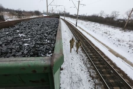 Activists walk along carriages loaded with coal from the occupied territories which they blocked at Kryvyi Torets station in the village of Shcherbivka in Donetsk region, Ukraine, February 14, 2017. Picture taken February 14, 2017. REUTERS/Konstantin Chernichkin