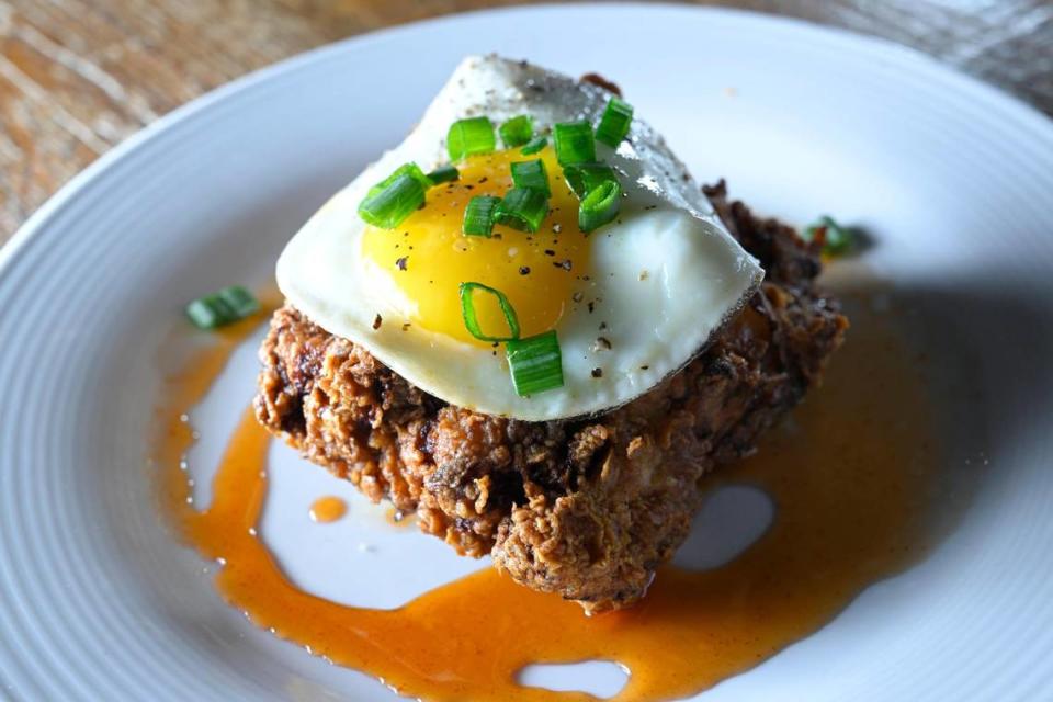 The Belfry’s chicken and biscuit features a buttermilk-marinated chicken thigh dipped in seasoned flour on top of a buttermilk biscuit, with honey sriracha and an egg.