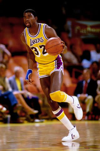 <p>Andy Hayt/NBAE via Getty</p> Magic Johnson Playing for the Lakers in 1985