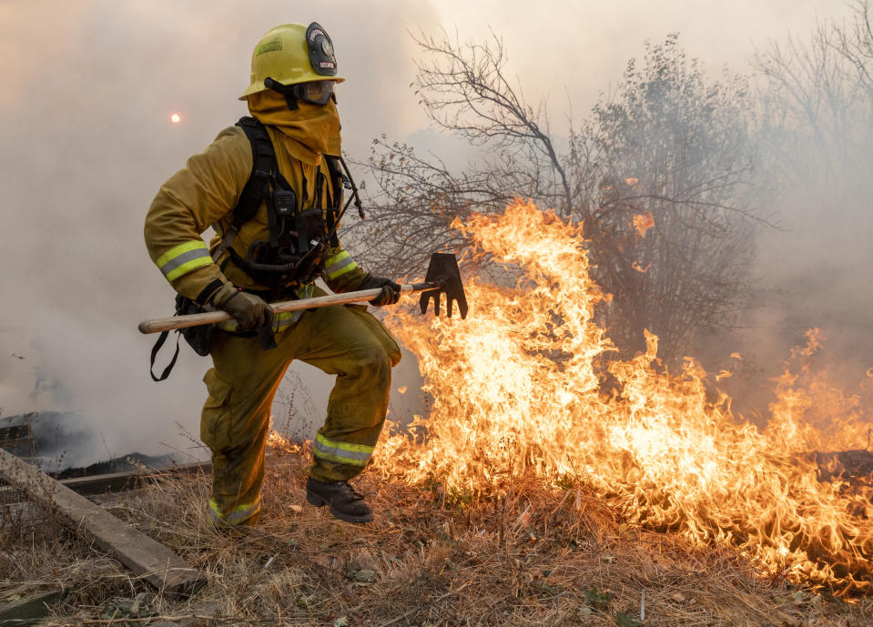 A firefighter from San Matteo helps fight the Kincade Fire in Sonoma County, Calif., on Sunday, Oct. 27, 2019. (Photo: Ethan Swope/AP)