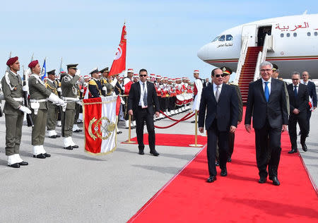 Egyptian President Abdel Fattah al-Sisi is welcomed by Tunisian Minister of Defense Abdelkarim Zbidi upon his arrival in Tunis to attend the 30th Arab Summit in this handout picture obtained by Reuters on March 31, 2019. The Egyptian Presidency/Handout