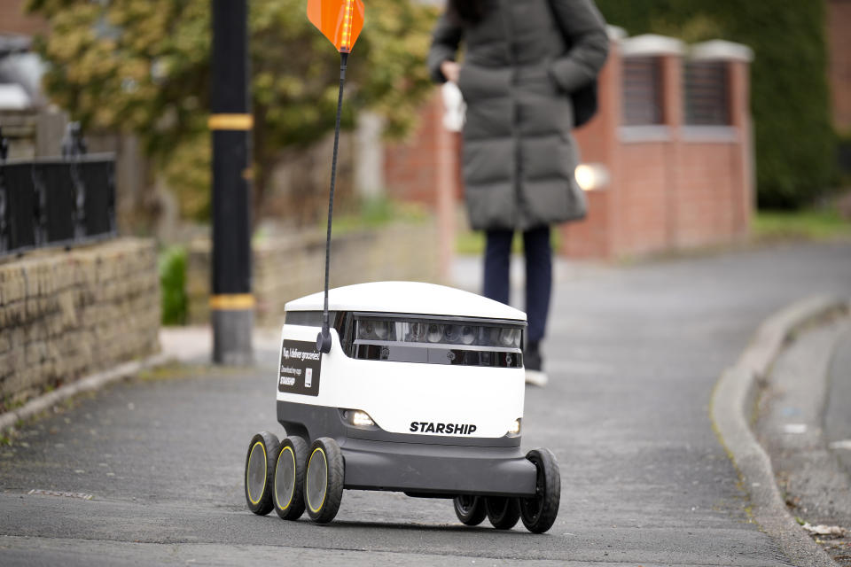 MANCHESTER, ENGLAND - MARCH 15: A Starship Technologies robotic vehicle delivers groceries to Co-op customers on March 15, 2023 in Manchester, England. The Co-op has been working with Starship Technologies to develop robots for local home delivery orders. The robots, small white packing cases on six wheels, use sensors and 12 cameras to enable them to navigate. They travel at walking speed, around 4mph, and their advanced technology enables them to manoeuvre around objects and people and wait until it is safe to cross the road. To deter thieves the little robot has a loud alarm which sounds if tampered with plus they are too heavy to pick up. (Photo by Christopher Furlong/Getty Images)