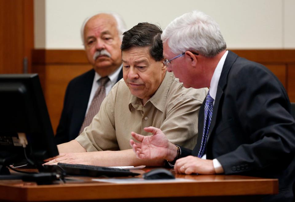 Former court-appointed guardian Paul Kormanik, middle, consults with his attorney Richard Cline before pleading guilty to 10 charges related to mistreating his wards in front of Judge Michael Holbrook in the Franklin County Common Pleas Court on Aug. 4, 2015. Kormanik was also represented by defense attorney S. Michael Miller, left. (Adam Cairns / The Columbus Dispatch)
