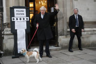 Britain's Prime Minister and Conservative Party leader Boris Johnson with his dog Dilyn as he leaves after voting in the general election at Methodist Central Hall, Westminster, London, Thursday, Dec. 12, 2019. The general election in Britain on Thursday will bring a new Parliament to power and may lead to a change at the top if Prime Minister Boris Johnson's Conservative Party doesn't fare well with voters. Johnson called the early election in hopes of gaining lawmakers to support his Brexit policy. (AP Photo/Frank Augstein)