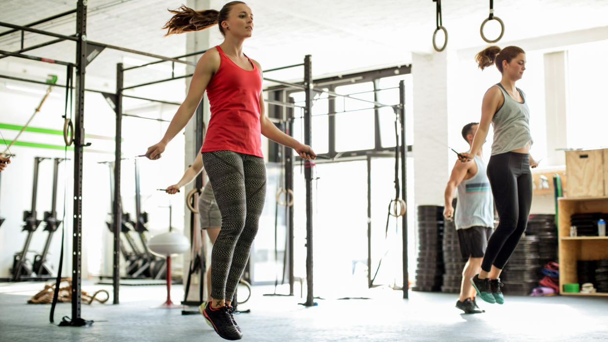  People in a CrossFit class completing double-unders . 