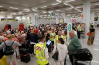 Passengers are seen at Thomas Cook check-in points at Mallorca Airport after the world's oldest travel firm collapsed, in Palma de Mallorca