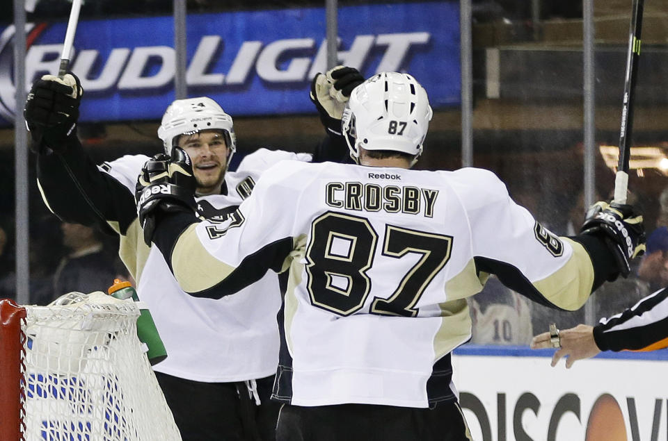Pittsburgh Penguins' Chris Kunitz, left, celebrates a goal with Sidney Crosby (87) during the third period of a second-round NHL Stanley Cup hockey playoff series against the New York Rangers, Wednesday, May 7, 2014, in New York. The Penguins won 4-2. (AP Photo/Frank Franklin II)