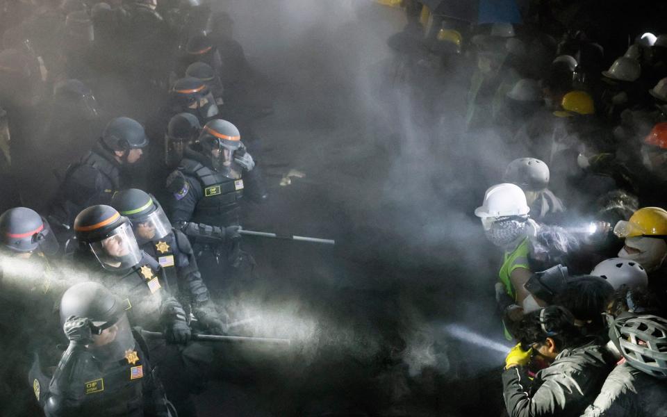 Protesters shone torches to try and fend off the advancing police