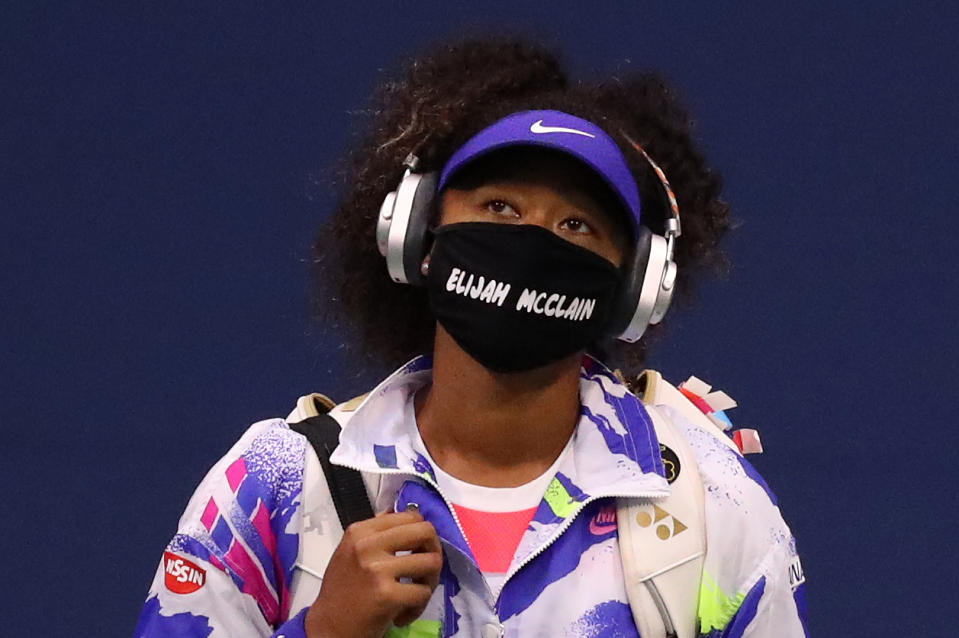 NEW YORK, NEW YORK - SEPTEMBER 02: Naomi Osaka of Japan walks in wearing a mask with the name Elijah McClain on it before her Women’s Singles second round match against  Camila Giorgi of Italy on Day Three of the 2020 US Open at the USTA Billie Jean King National Tennis Center on September 2, 2020 in the Queens borough of New York City. McClain was shot and killed by police on Aurora, Colorado August 24, 2020. (Photo by Matthew Stockman/Getty Images)