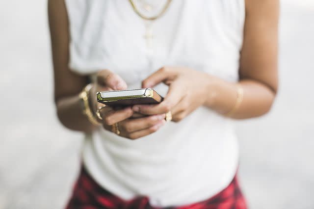 Chad Springer/Getty Images A woman checking a text message (stock image)