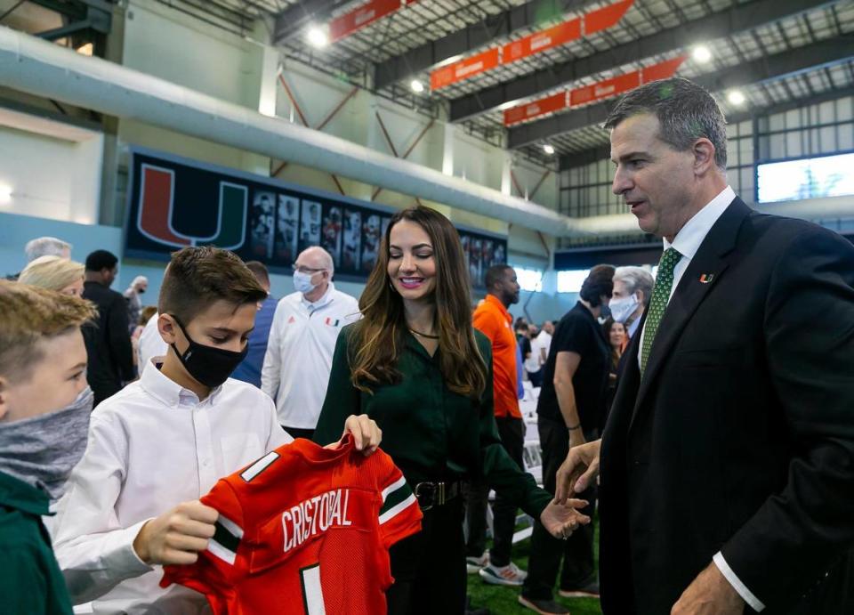 From right to left: Mario Cristobal, his wife, Jessica Cristobal, and their kids, Mario Mateo Cristobal, 11, and Rocco Cristobal, 10, are in attendance at a press conference introducing Mario Cristobal as the newly hired head football coach of the Miami Hurricanes at the Carol Soffer Indoor Practice Facility inside the University of Miami in Coral Gables, Florida on Tuesday, December 7, 2021.