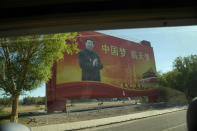 Chinese President Xi Jiping is seen on a propaganda board with the slogan "China Dream, Space Dream" from inside a bus at the Jiuquan Satellite Launch Center near Jiuquan in Northwestern China's Gansu province on Wednesday, June 16, 2021. China's space program has been a massive source of national pride, embodying China's rise from poverty to the world's second largest economy over the past four decades. That has helped shore up the rule of the Communist Party whose authoritarian rule and strict limits on political activity have been tolerated by most Chinese as long in the expectation that the country continues to progress in material terms. (AP Photo/Ng Han Guan)