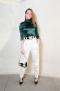 Emma Stone's emerald green roll-neck is tucked into a pair of slim white trousers with a zip detailing. She's in head-to-toe Louis Vuitton for the Louis Vuitton Cruise 2020 show on 8 May. <em>[Photo: Getty]</em>