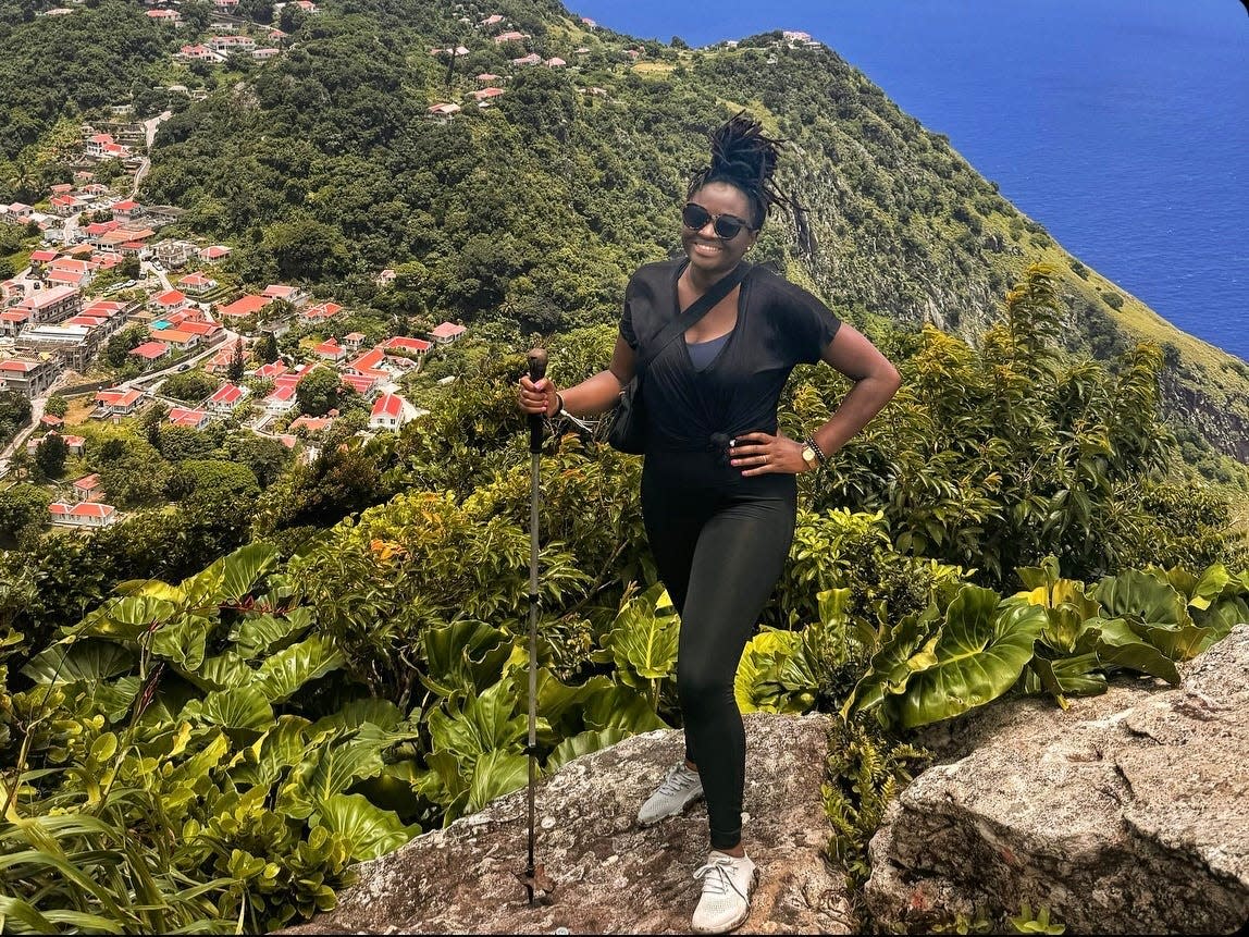 Mariette wearing watershoes, leggings, and a belt bag on a hike in the Caribbean Island of Saba.