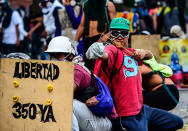 <p>A opposition demonstrator uses a sligshot to clash with police during an anti-government protest in Caracas, on July 26, 2017. (Photo: Ronaldo Schemidt/AFP/Getty Images) </p>