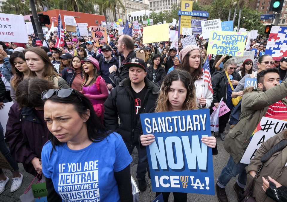 FILE - In this Feb. 18, 2017, file photo, thousands of people take part in the "Free the People Immigration March," to protest actions taken by President Donald Trump and his administration, in Los Angeles. A federal appeals court has given the Trump administration a rare legal win in its efforts to crack down on sanctuary cities. In a 2-1 decision Friday, July 12, 2019, the 9th U.S. Circuit Court of Appeals said the Justice Department was within its rights to give priority status for multimillion-dollar community policing grants to departments that agree to cooperate with immigration officials. (AP Photo/Ringo H.W. Chiu, File)