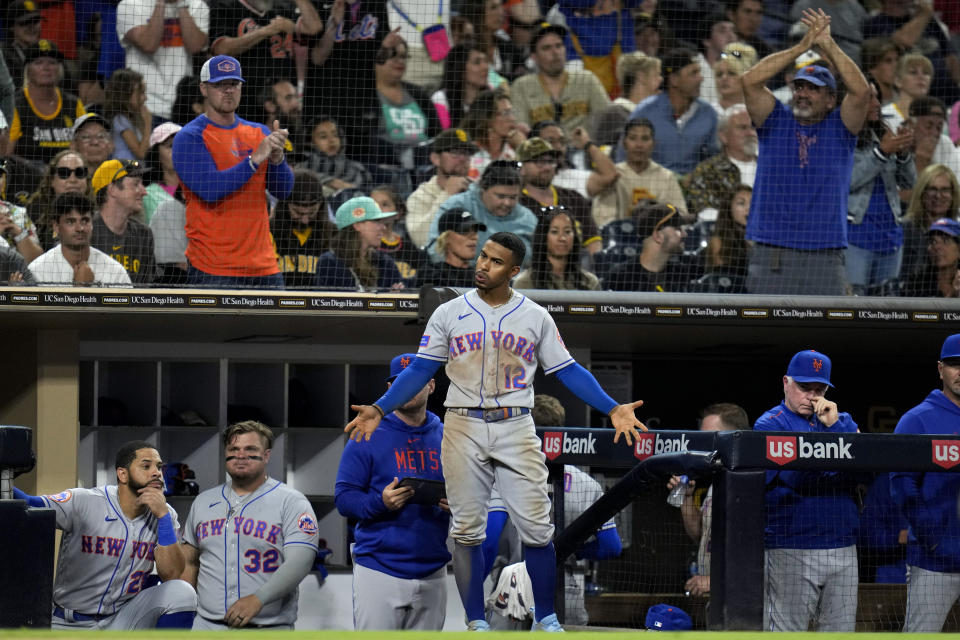 CORRECTS TO 10TH INNING, INSTEAD OF NINTH - New York Mets' Francisco Lindor, center, reacts after Starling Marte scored from second on a double by Jeff McNeil during the 10th inning of a baseball game against the San Diego Padres, Friday, July 7, 2023, in San Diego. (AP Photo/Gregory Bull)